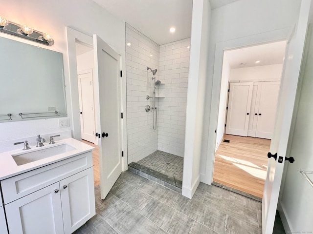 bathroom featuring vanity and a tile shower