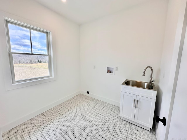 laundry area featuring cabinets, sink, and washer hookup