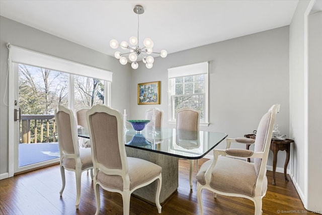 dining room featuring an inviting chandelier, plenty of natural light, and dark hardwood / wood-style floors