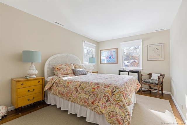 bedroom with dark hardwood / wood-style floors