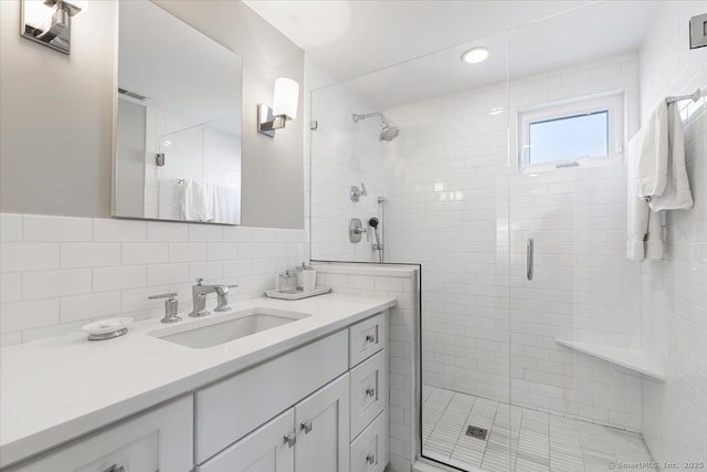 bathroom with vanity and a shower with shower door