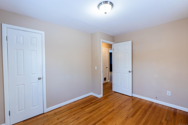 unfurnished room featuring hardwood / wood-style flooring