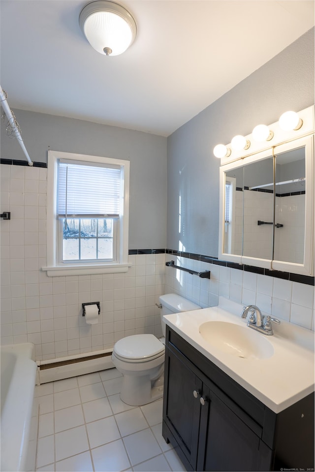 bathroom featuring tile walls, vanity, a baseboard heating unit, toilet, and tile patterned floors