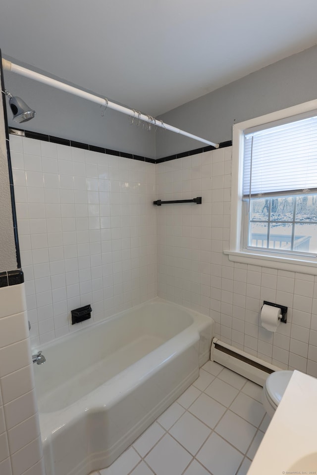 bathroom with toilet, tiled shower / bath, tile walls, tile patterned flooring, and a baseboard heating unit