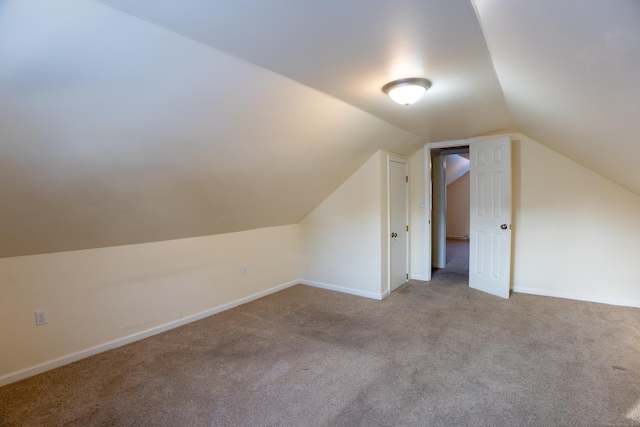 additional living space with lofted ceiling and light carpet