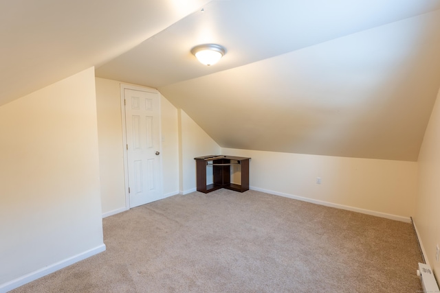 additional living space with light carpet and lofted ceiling