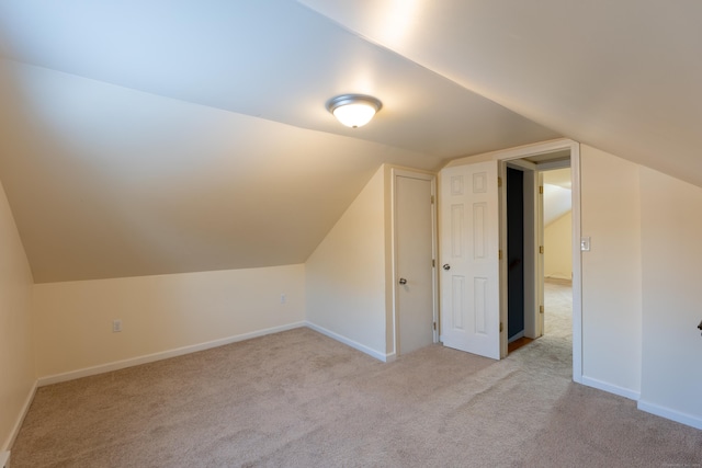 additional living space featuring light carpet and lofted ceiling