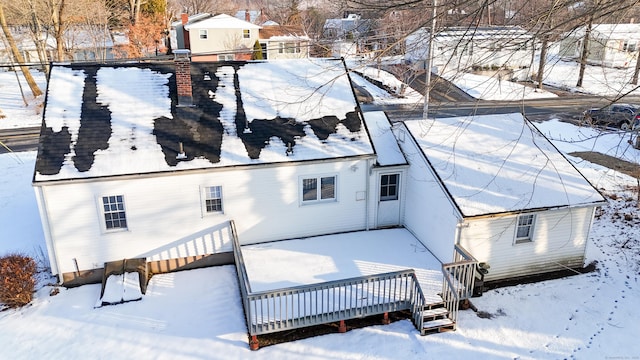 snow covered property featuring a deck