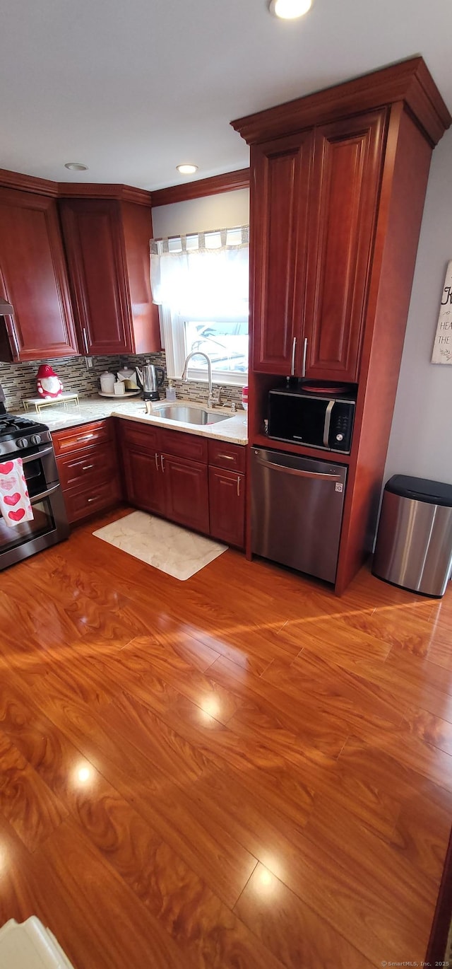 30 Grove Pl, Danbury, CT 06810 - kitchen featuring stainless steel appliances, light countertops, backsplash, and dark brown cabinets