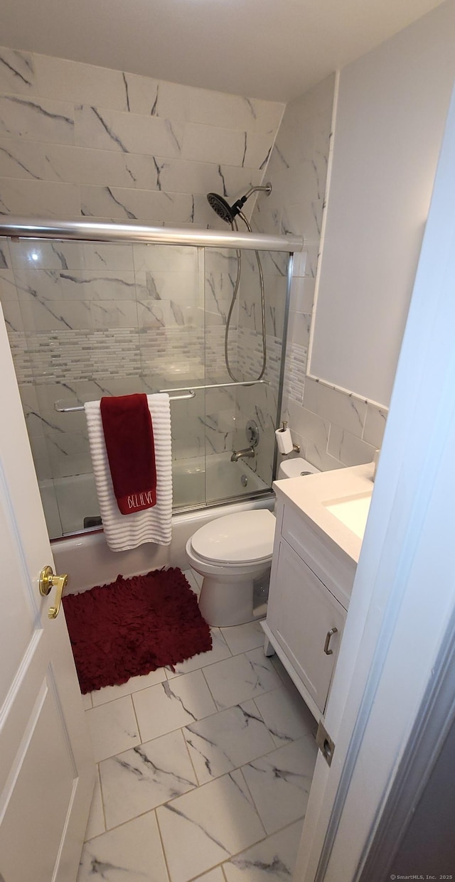 30 Grove Pl, Danbury, CT 06810 - full bath featuring marble look tile flooring, shower / bath combination with glass door, and vanity