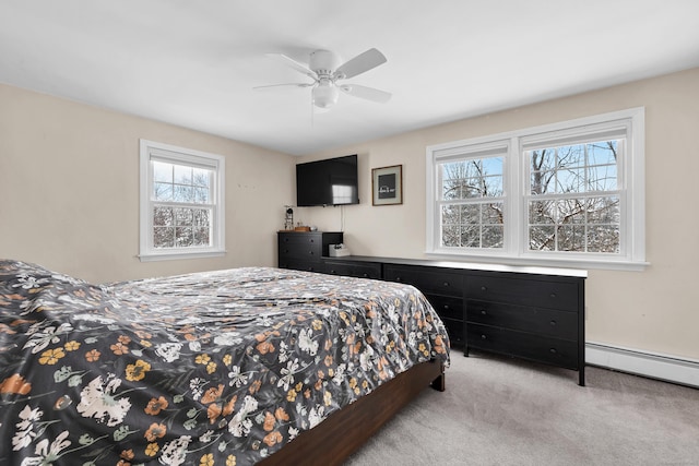 bedroom with a baseboard radiator, light colored carpet, and ceiling fan