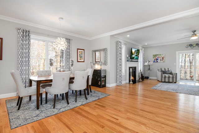 dining area featuring crown molding and light hardwood / wood-style flooring