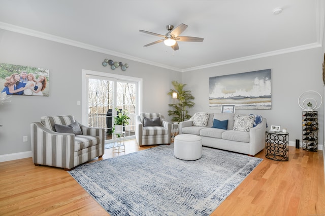 living room featuring ornamental molding, wood-type flooring, and ceiling fan