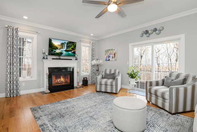 living room featuring crown molding, hardwood / wood-style floors, and a wealth of natural light