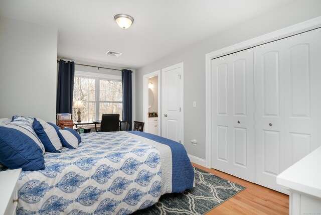 bedroom featuring hardwood / wood-style floors and a closet