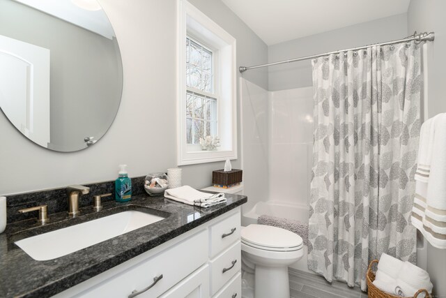 full bathroom with vanity, toilet, and shower / bath combo