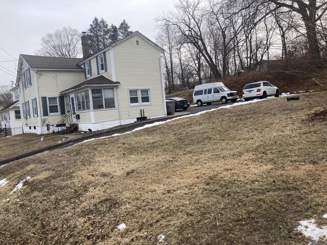 view of property exterior featuring a lawn