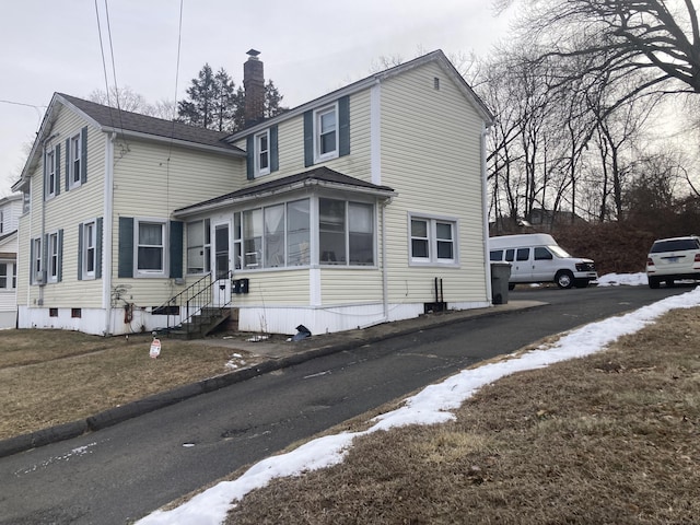 view of side of home with a sunroom