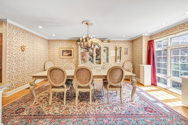 dining room with crown molding, a chandelier, and light hardwood / wood-style floors