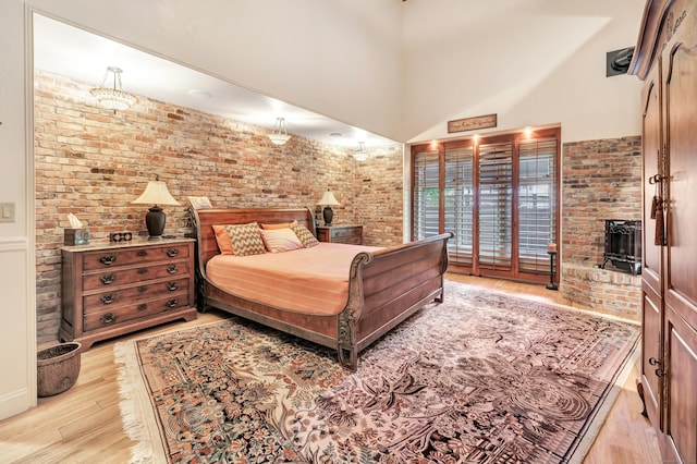 24 Brierwood Dr, Orange, CT 06477 - bedroom with wood finished floors, brick wall, and a high ceiling