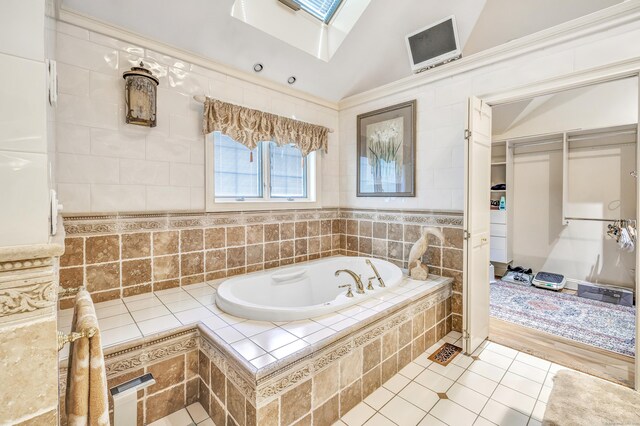 24 Brierwood Dr, Orange, CT 06477 - bathroom featuring a bath, a skylight, tile patterned floors, and vaulted ceiling