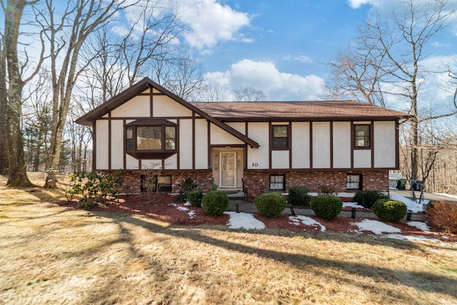 tudor-style house featuring a front lawn