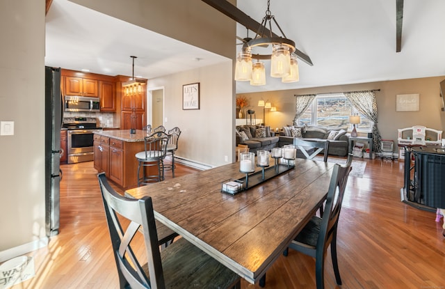 dining room with light wood-type flooring and baseboard heating