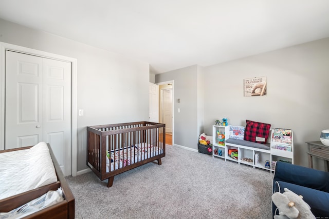 carpeted bedroom featuring a closet and a crib