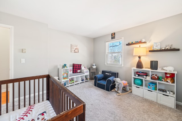 bedroom featuring a nursery area and carpet flooring