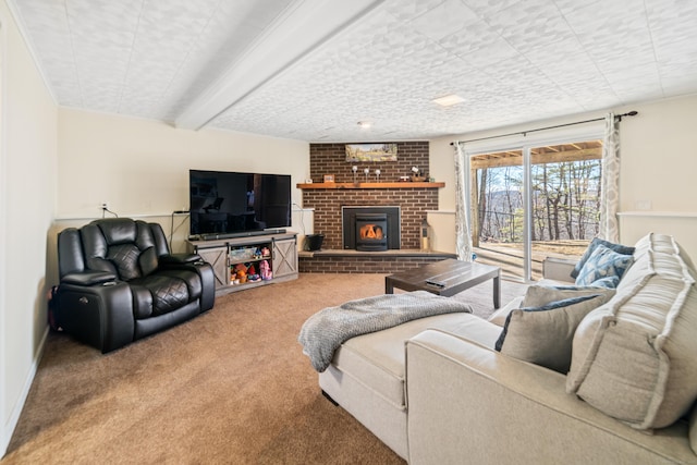 living room featuring beamed ceiling, a fireplace, and carpet flooring