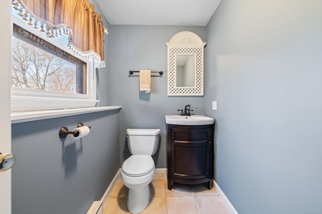 bathroom featuring vanity, toilet, and tile patterned flooring