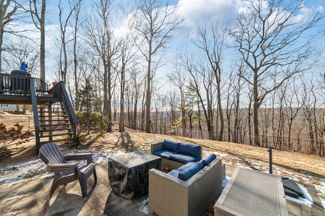 view of patio with an outdoor living space and a deck