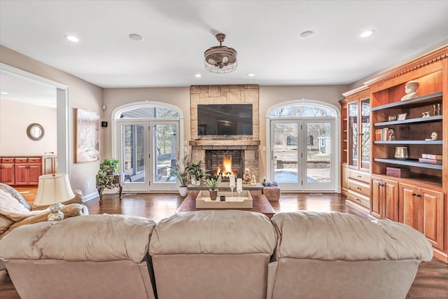 living area featuring a wealth of natural light, recessed lighting, dark wood-style floors, and a fireplace