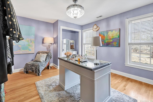 office featuring visible vents, baseboards, a chandelier, and light wood finished floors