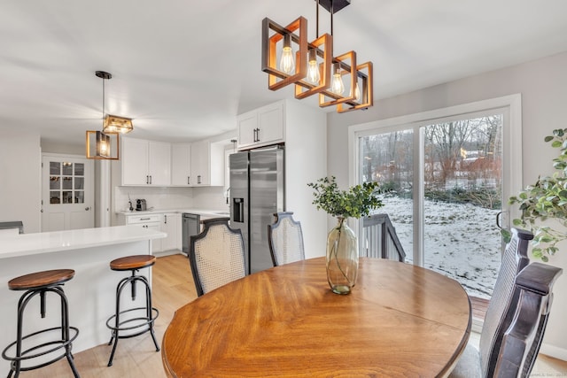 dining room with a notable chandelier and light hardwood / wood-style floors