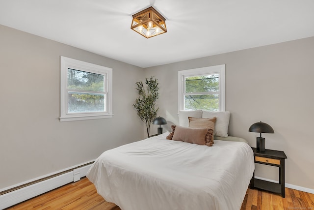 bedroom featuring a baseboard radiator and light wood-type flooring