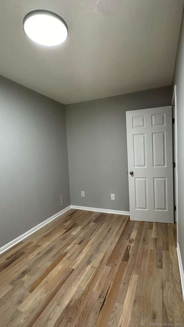 spare room with light hardwood / wood-style flooring