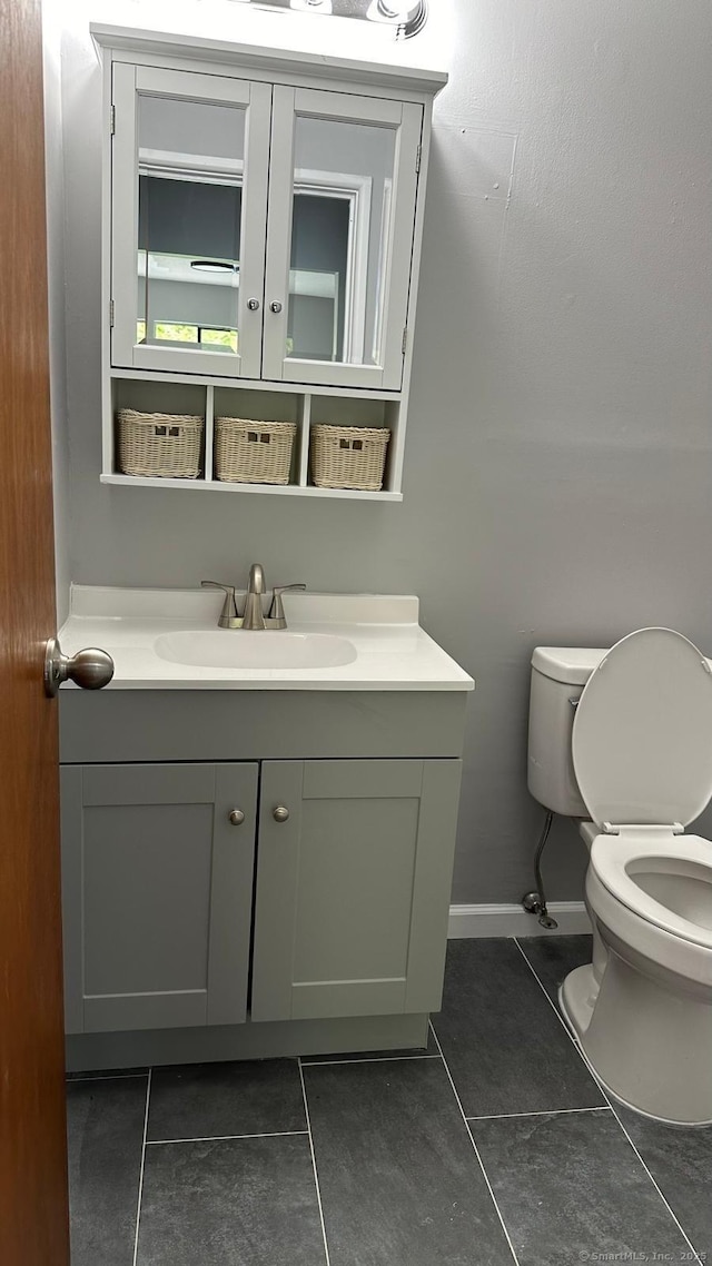 bathroom with vanity, tile patterned floors, and toilet