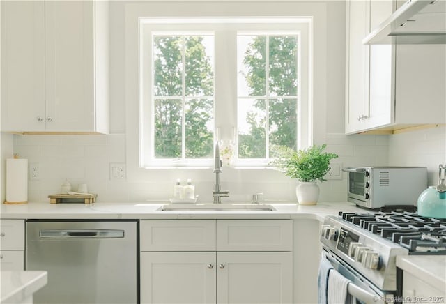 kitchen featuring white cabinetry, sink, decorative backsplash, and stainless steel appliances