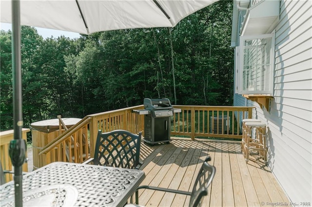 wooden terrace featuring a grill