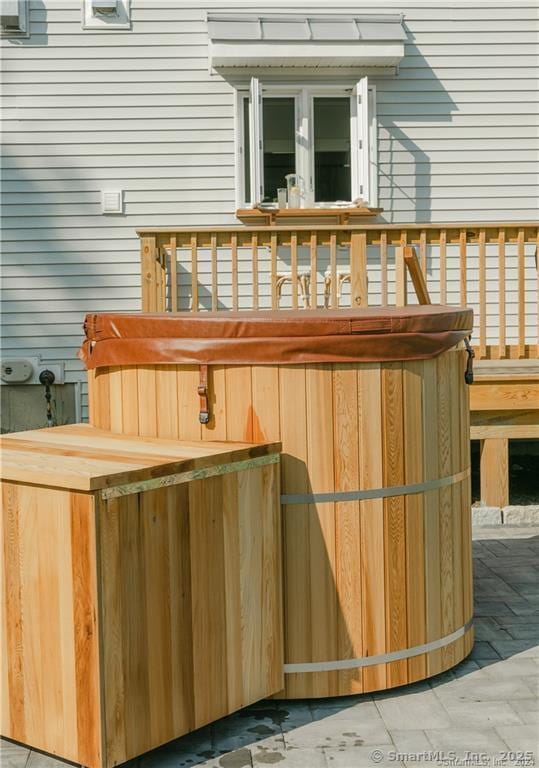 wooden deck with a hot tub