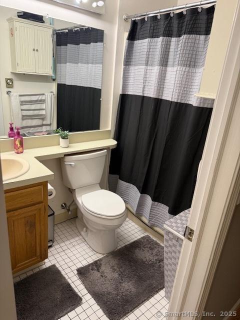 bathroom with tile patterned flooring, vanity, a shower with curtain, and toilet