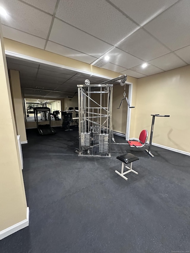 workout area featuring a paneled ceiling