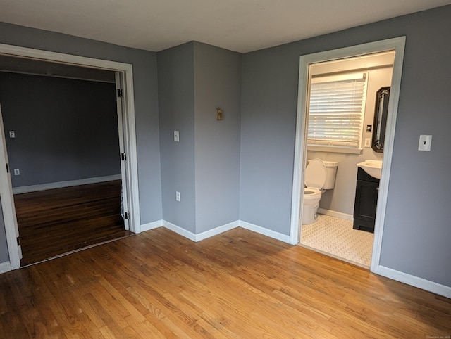 interior space with light hardwood / wood-style floors and ensuite bathroom