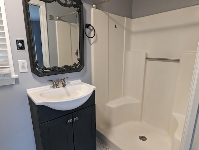 bathroom featuring vanity and a shower