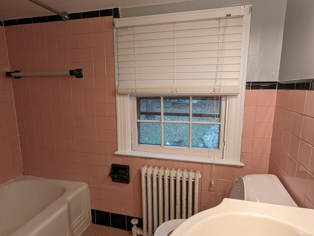 bathroom featuring shower / bathing tub combination, radiator heating unit, tile walls, and toilet