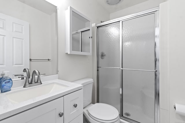 bathroom with vanity, toilet, and walk in shower