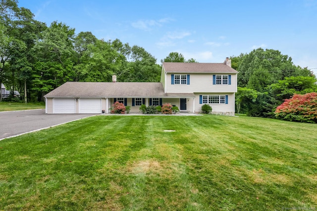 view of front of house with a garage and a front lawn