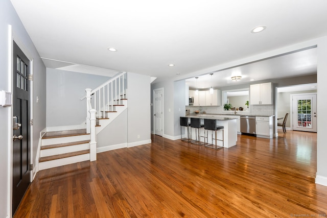 unfurnished living room featuring hardwood / wood-style flooring