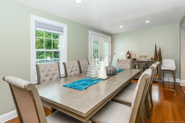 dining room with dark hardwood / wood-style flooring, french doors, and a healthy amount of sunlight